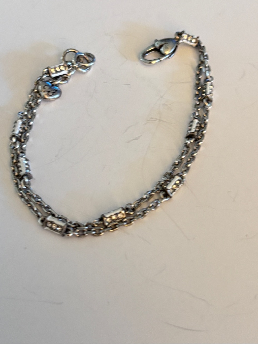 authentic Brighton double-strand chain bracelet featuring a silver-plate finish.